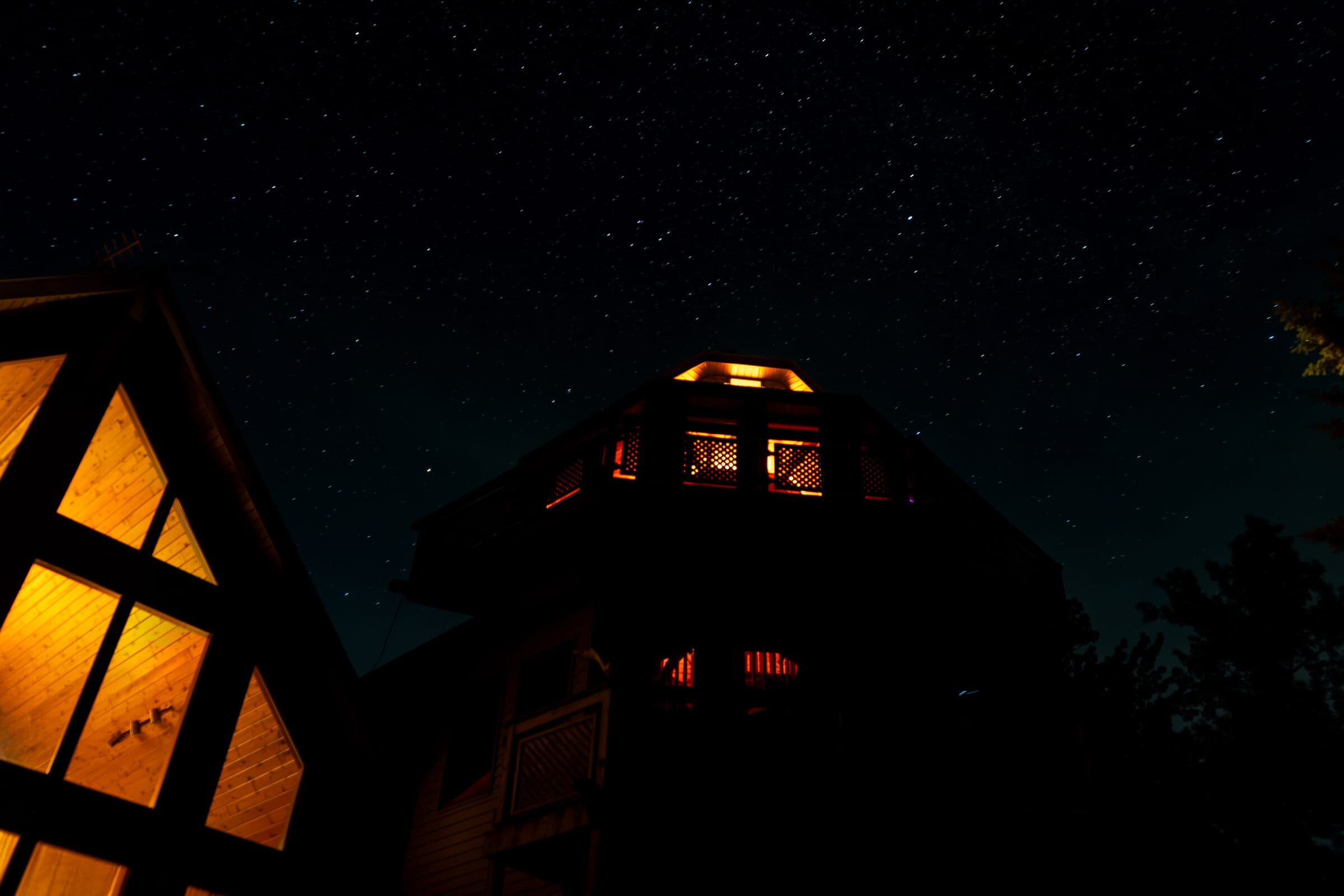 A-frame cabin under a clear night sky